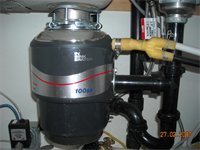 Brent Brandolino installed this new garbage disposal to replace the old leaky plumbing under the kitchen sink.