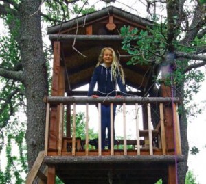 Cate in her custom treehouse